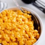 Hidden Veggie Mac & Cheese on table in white bowl with measuring cups