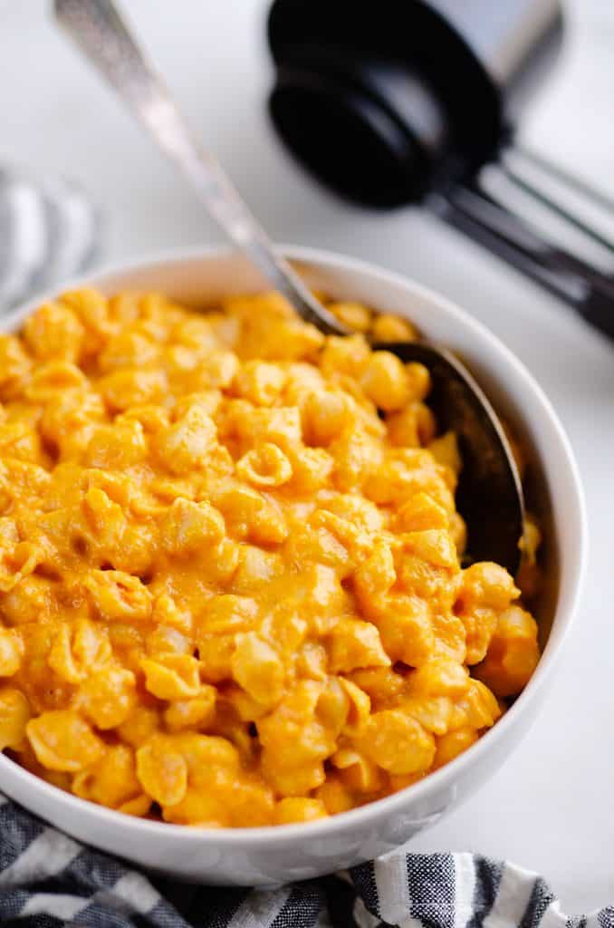 Hidden Veggie Mac & Cheese on table in white bowl with measuring cups