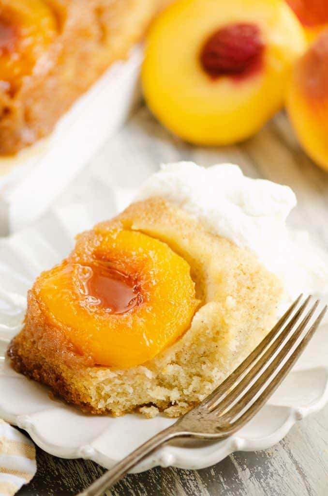 Peach Upside Down Cake on white plate with fork