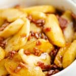 Caramelized Bacon & Apples in white bowl on table