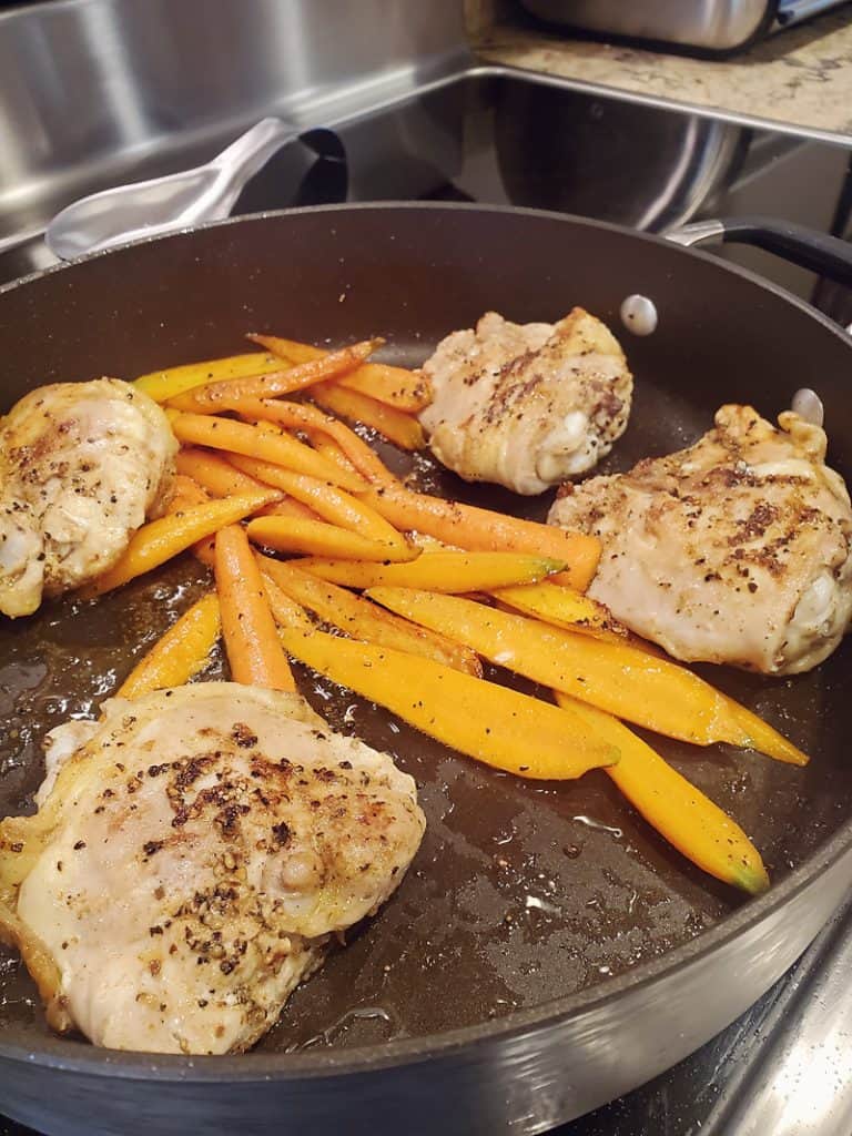 chicken and carrots in skillet