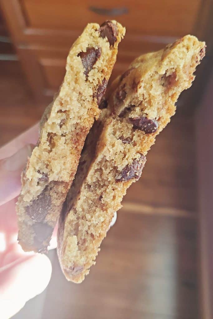 Gobble chocolate chip cookie broken in half in hand