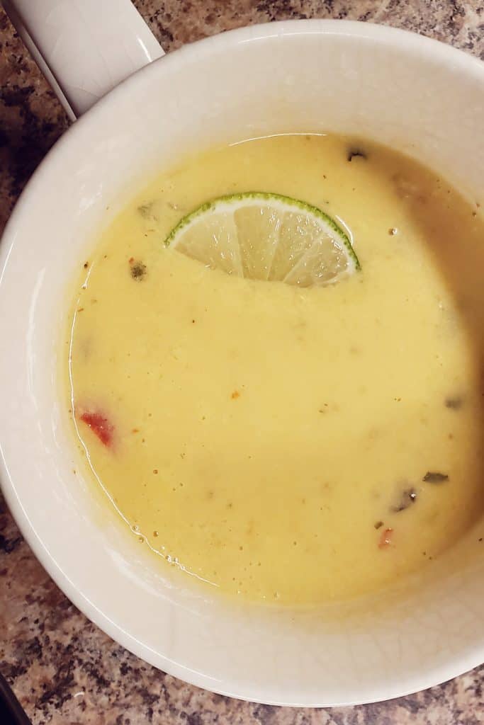 Gobble Thai Coconut Curry Soup in white mug with slice of lime