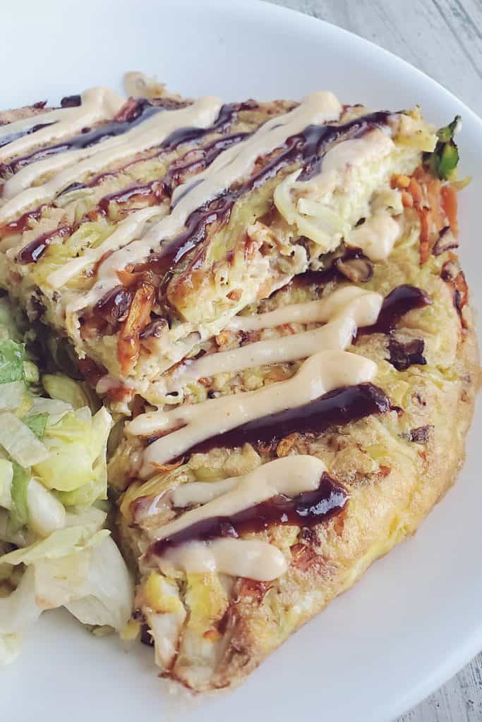 Gobble Japanese Okonomiyaki Yakisoba Noodle Omlette topped with sriracha mayo on plate