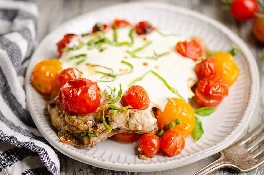 Honey Balsamic Caprese Chicken on white plate with napkin