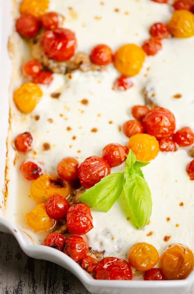 Honey Balsamic Caprese Chicken and tomatoes in white baking dish
