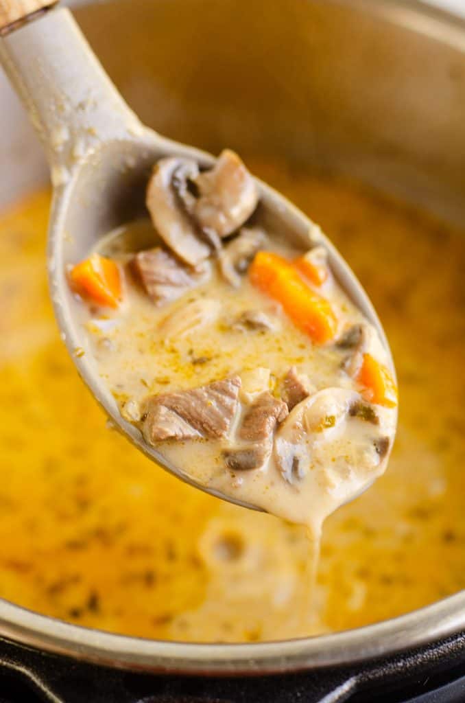 Creamy Mushroom Beef Soup spoonful with cream over instant pot