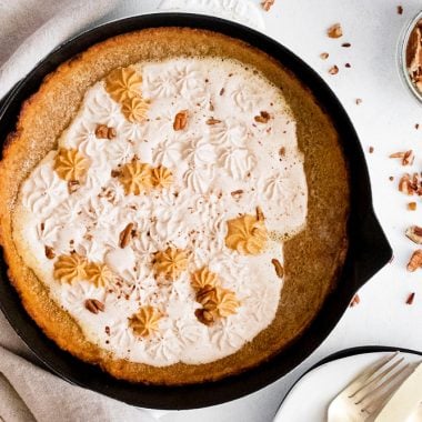 Pumpkin Spicy Dutch Baby on white table with pumpkin and pecans