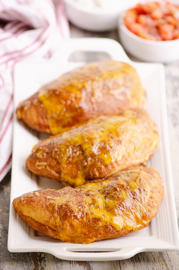 Air Fryer Taco Calzones on white platter with salsa