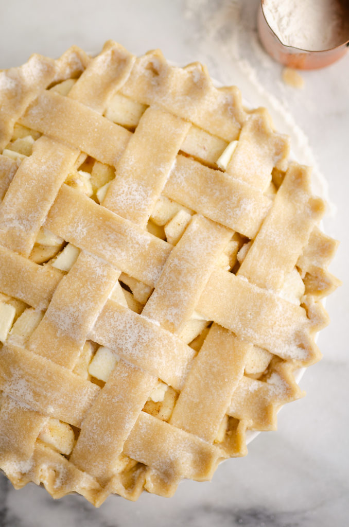 Old Fashioned Apple Pie with lattice crust on marble table