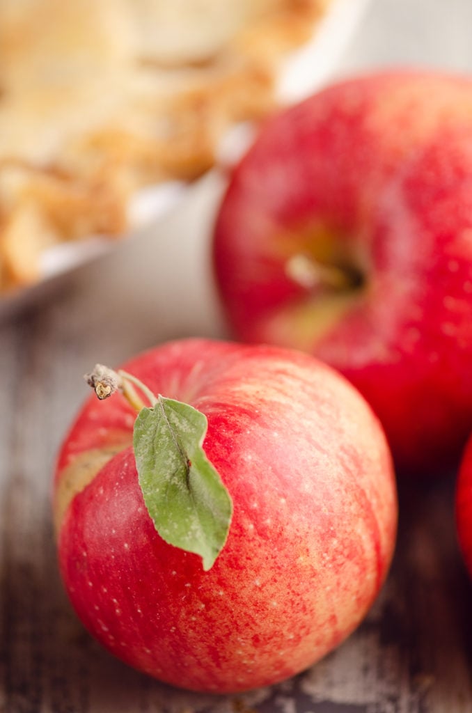 Baking apples on table with pie