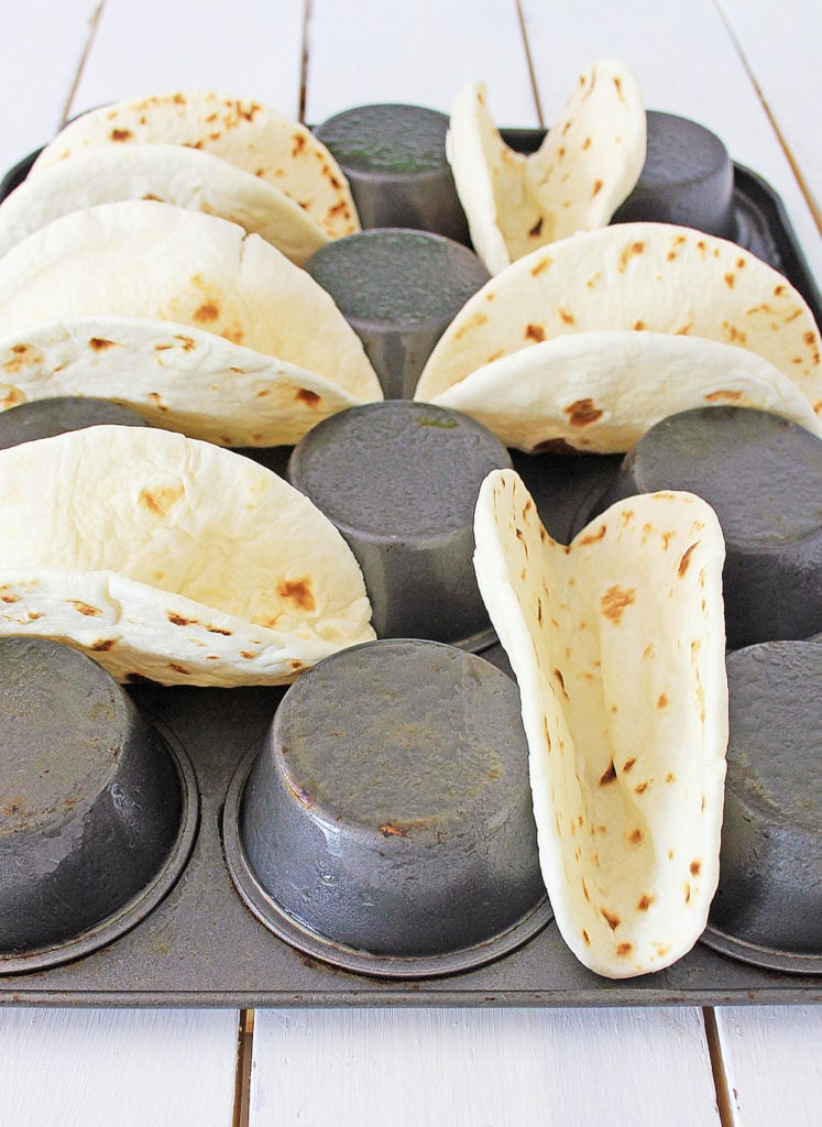 baked flour tortilla shells made in a muffin tin