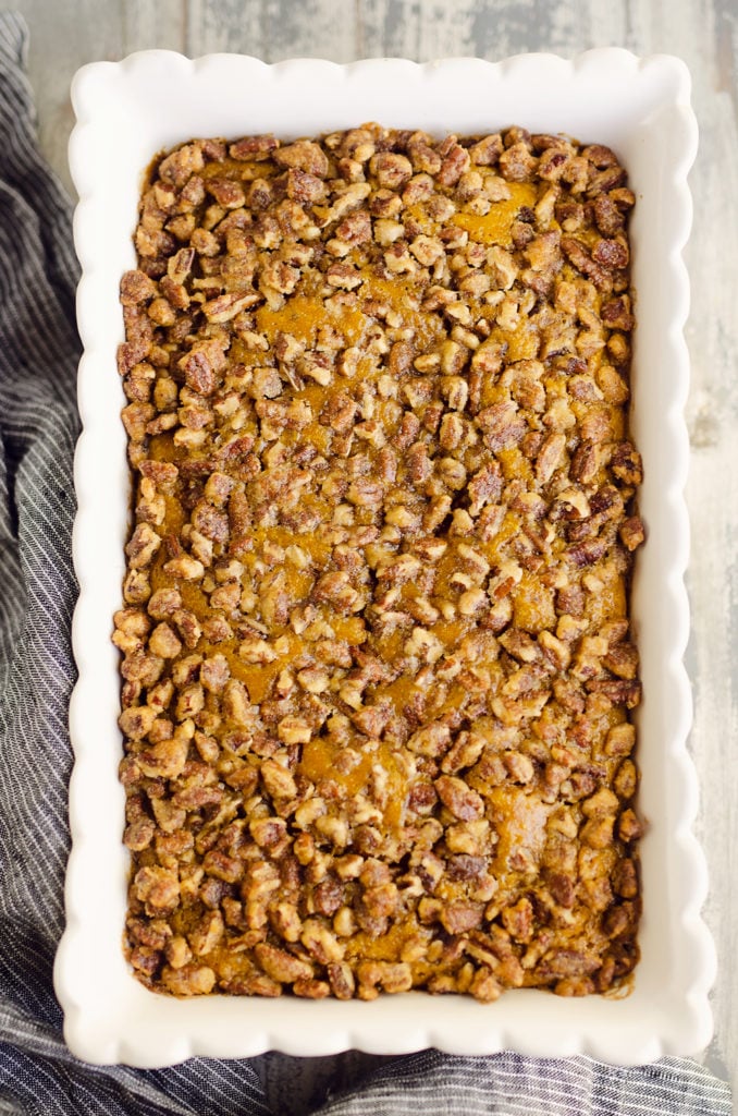 Pumpkin Pecan Custard Pie Bars in scalloped white pan