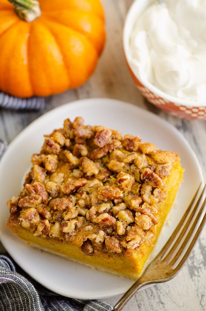 Pumpkin Pecan Custard Pie Bars on white plate with fork