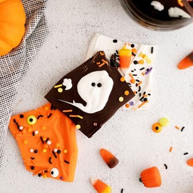 Halloween Ghost and orange chocolate bark on white table with sprinkles