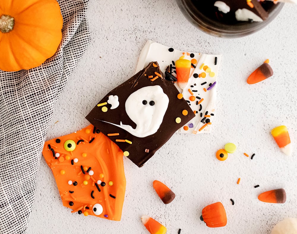 Halloween Ghost and orange chocolate bark on white table with sprinkles