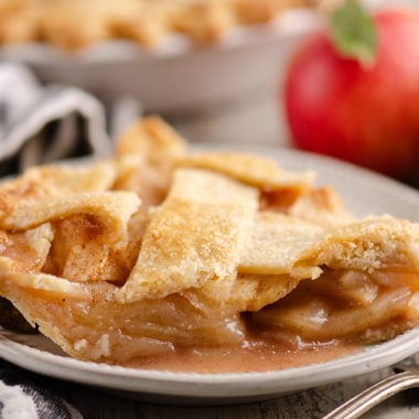 Old Fashioned Apple Pie slice on white plate with napkin