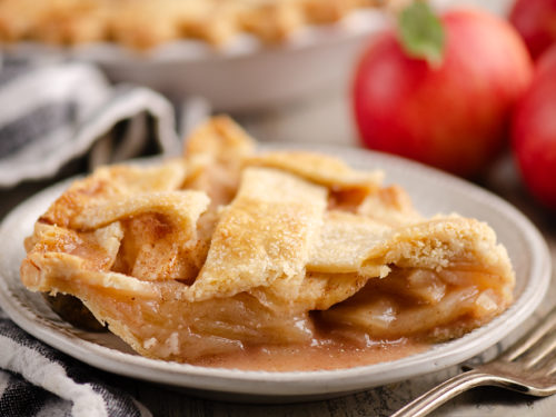 Old Fashioned Apple Pie slice on white plate with napkin