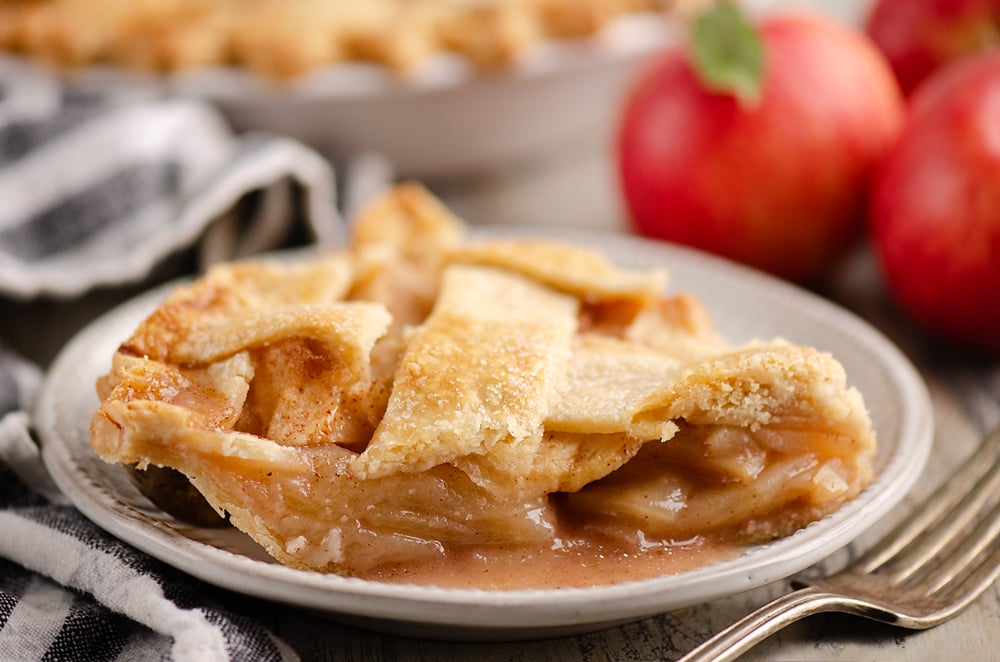 Old Fashioned Apple Pie slice on white plate with napkin