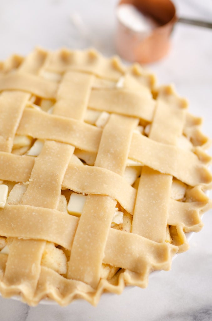 Old Fashioned Apple Pie on marble table with lattice crust