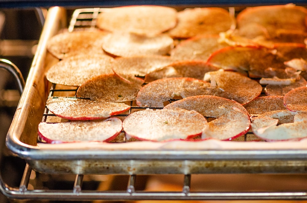 apple slices in oven baking to make apple chips