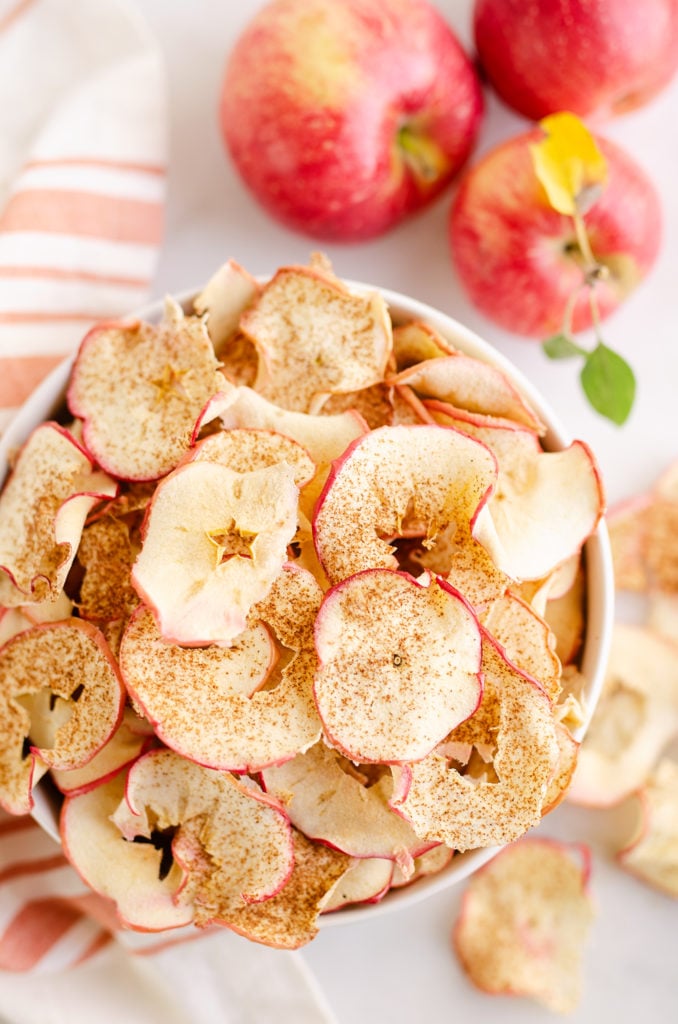 baked apple chips in white bowl