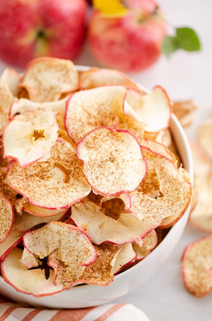 baked apple chips in white bowl