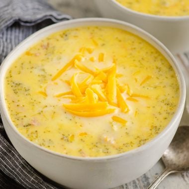 Pressure Cooker Cheesy Ham & Broccoli Soup in white bowl with glass jar of milk