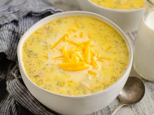 Pressure Cooker Cheesy Ham & Broccoli Soup in white bowl with glass jar of milk