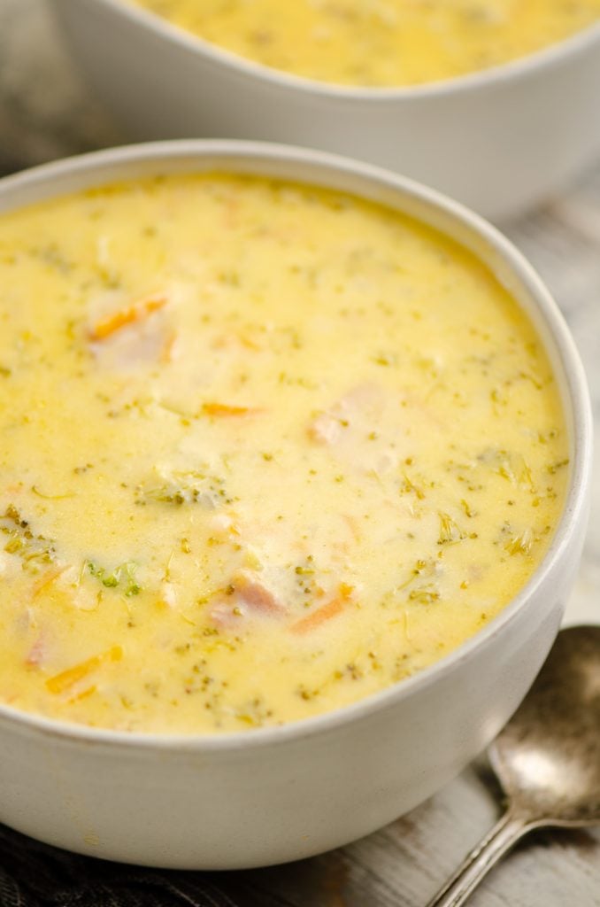 Pressure Cooker Cheesy Ham & Broccoli Soup in white bowl with spoon