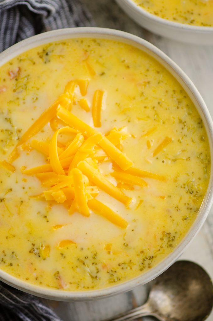 Pressure Cooker Cheesy Ham & Broccoli Soup in bowl topped with cheddar cheese