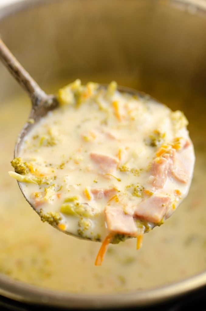 laddle full of Pressure Cooker Cheesy Ham & Broccoli Soup in Instant Pot