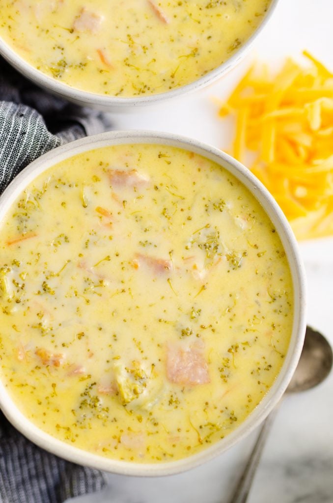 Pressure Cooker Cheesy Ham & Broccoli Soup on white table with napkin and spoon