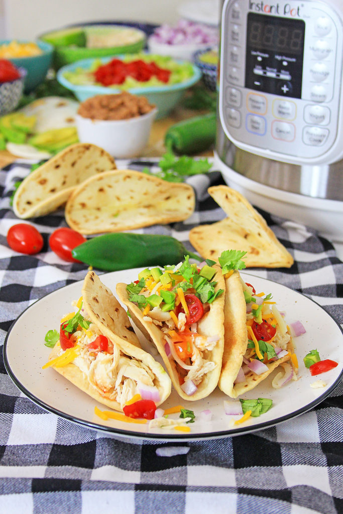 Pressure Cooker Chili Lime Chicken Tacos on table with checkered tablecloth with Instant Pot