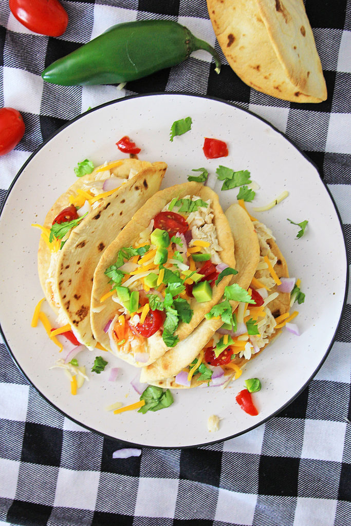 Pressure Cooker Chili Lime Chicken Tacos on white plate and checkered tablecloth