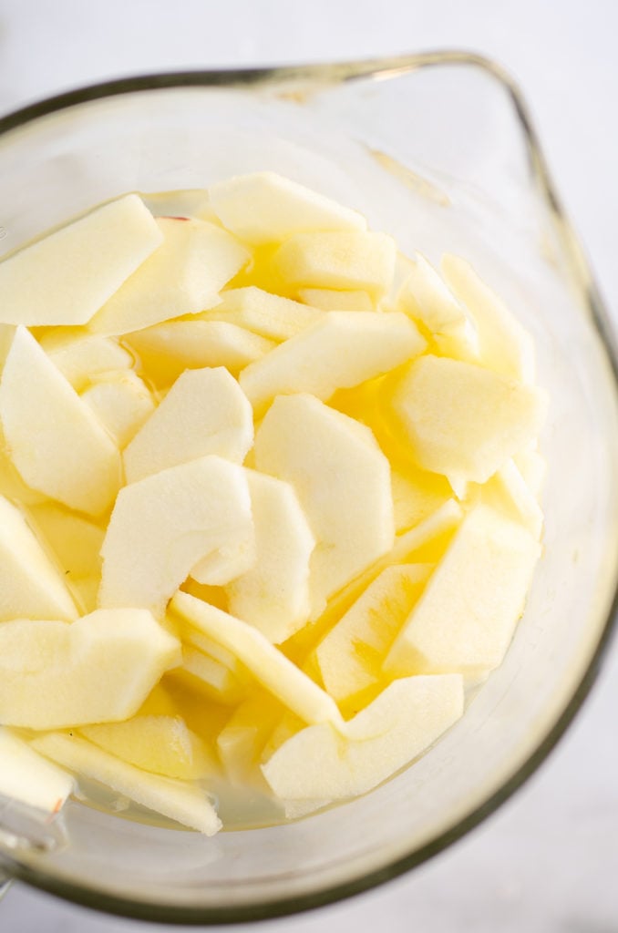 sliced baking apples in measuring cup