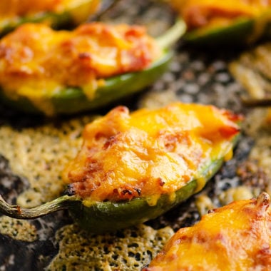 Cheesy BBQ Pork Jalapeno Poppers baked with cheese on sheet pan