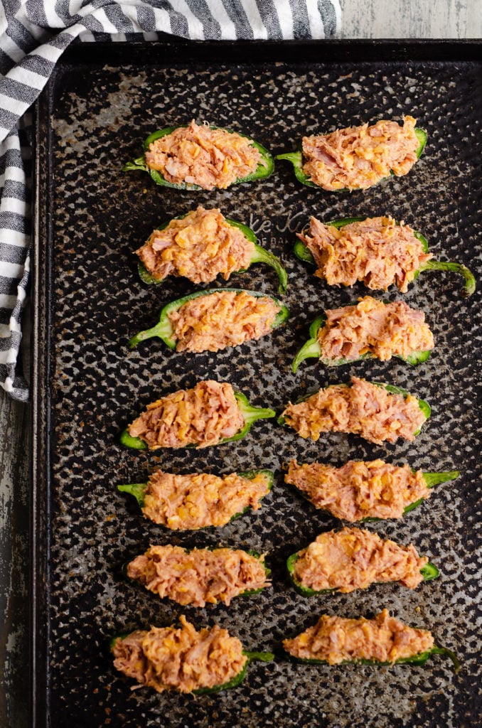 Cheesy BBQ Pork Jalapeno Poppers on black sheet pan