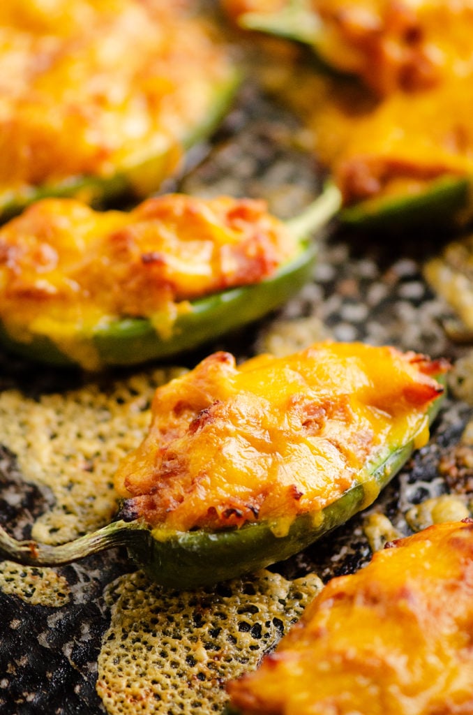 Cheesy BBQ Pork Jalapeno Poppers baked with cheese on sheet pan