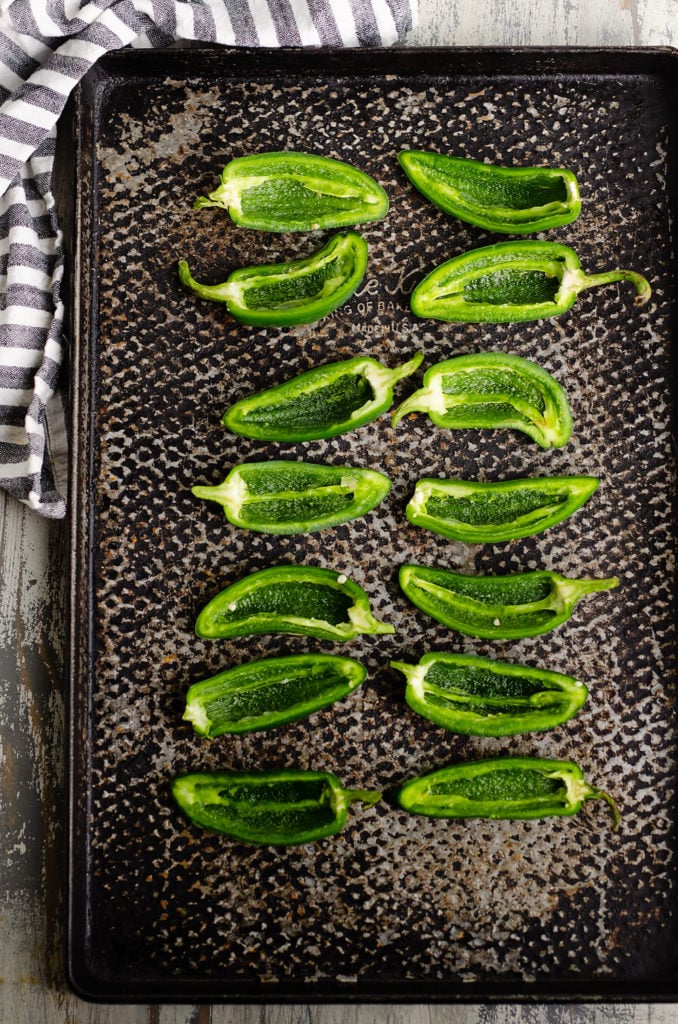 Jalapenos halved and seeded on sheet pan