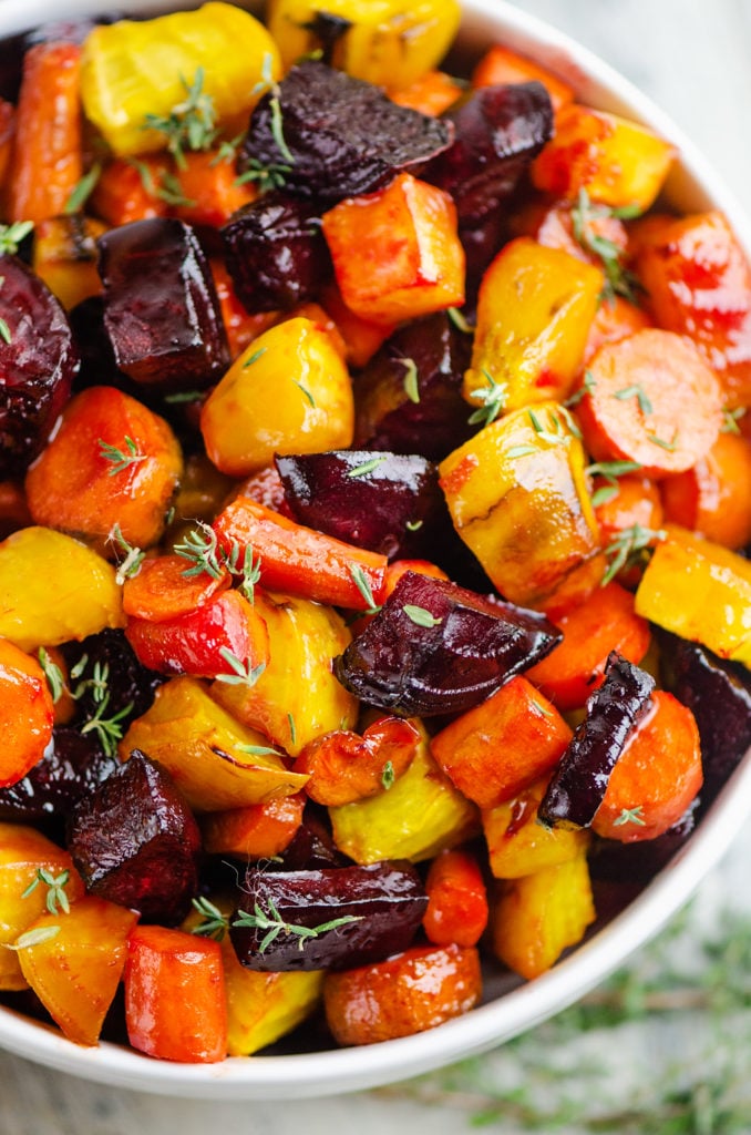 Honey Roasted Beets & Carrots in white bowl topped with fresh thyme