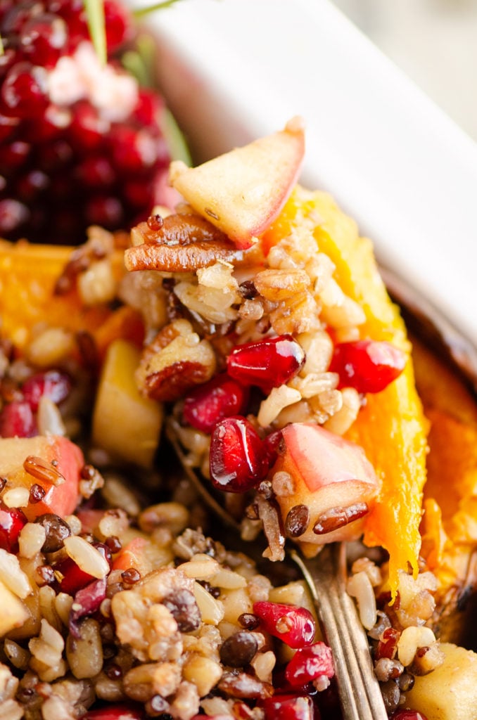 Stuffed Butternut Squash with Apples, Pomegranates & Grains spoonful being scooped out