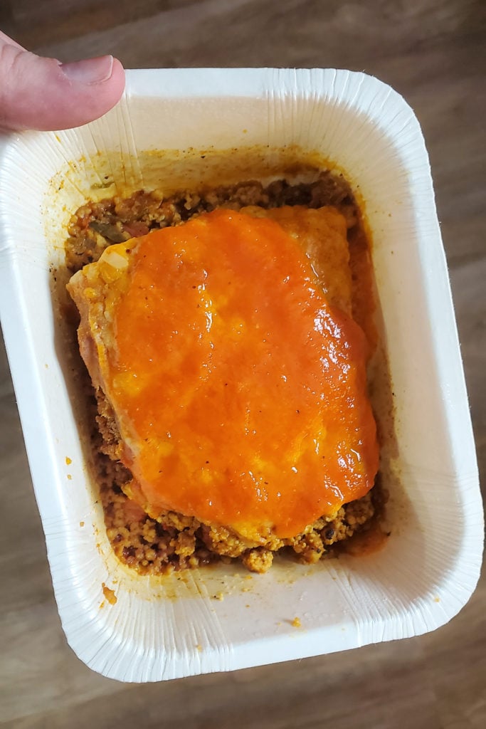 Veestro Enchilada Casserole vegan meal in white paper container