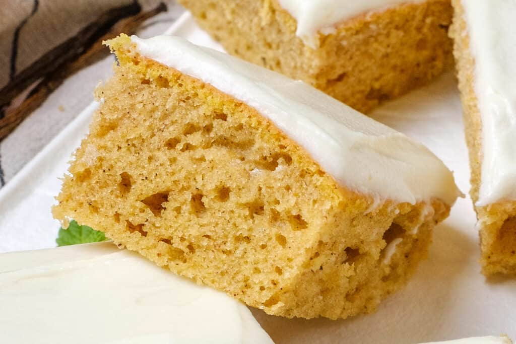 pumpkin cake bar with cream cheese frosting stacked