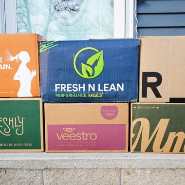 prepared meal delivery boxes stacked on front step