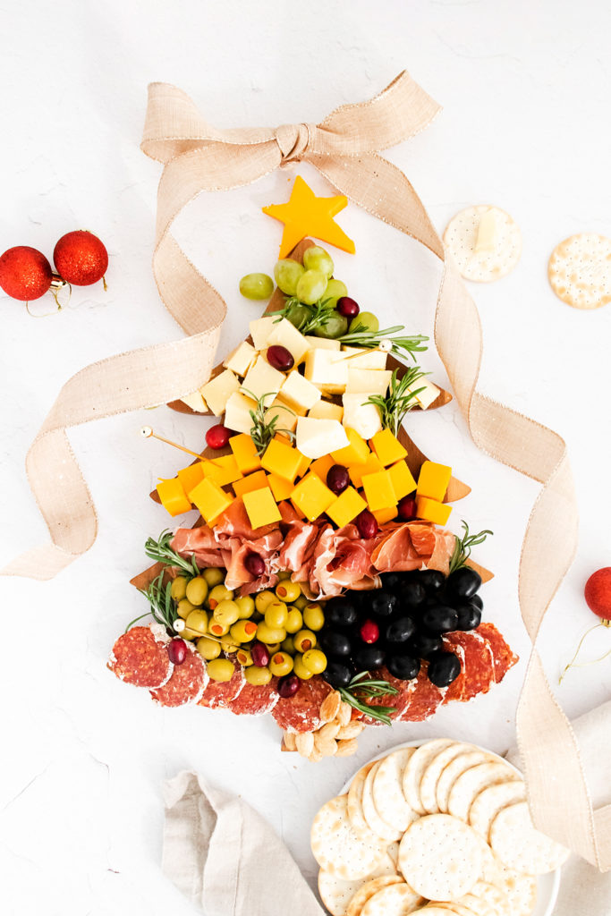 christmas tree cutting board topped with meat and cheese