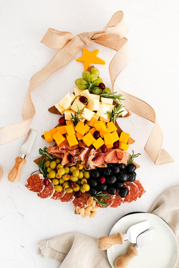christmas tree cutting board topped with charcuterie