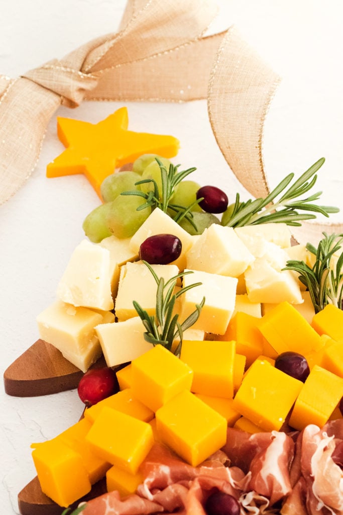 cheese star and rosemary on christmas tree charcuterie board