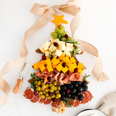 christmas tree cutting board topped with meat and cheese