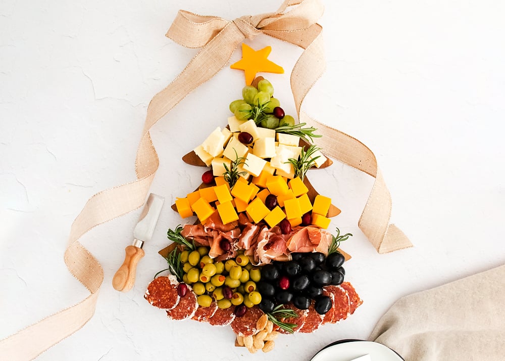 christmas tree cutting board topped with meat and cheese